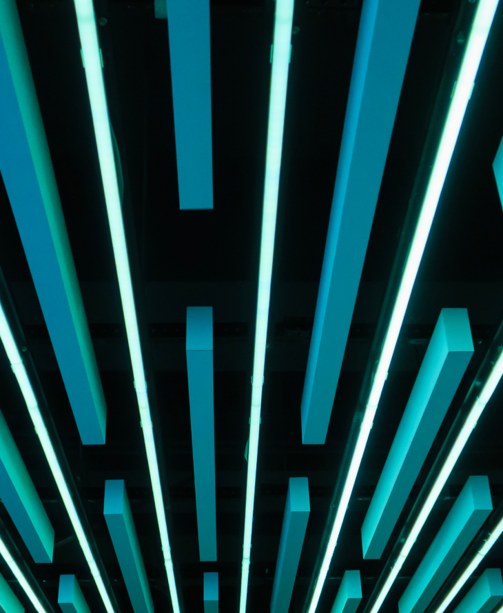 Abstract depiction of blue rectangles coming out of a black ceiling.