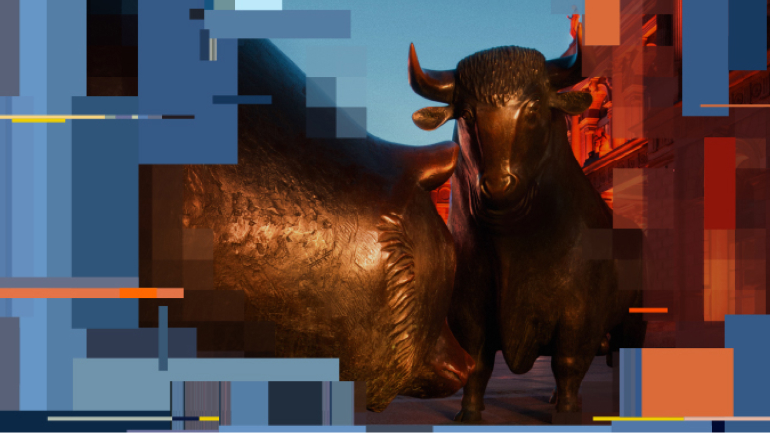 Two bronze bull statues positioned closely together, with a warm light casting shadows on their textured surfaces.