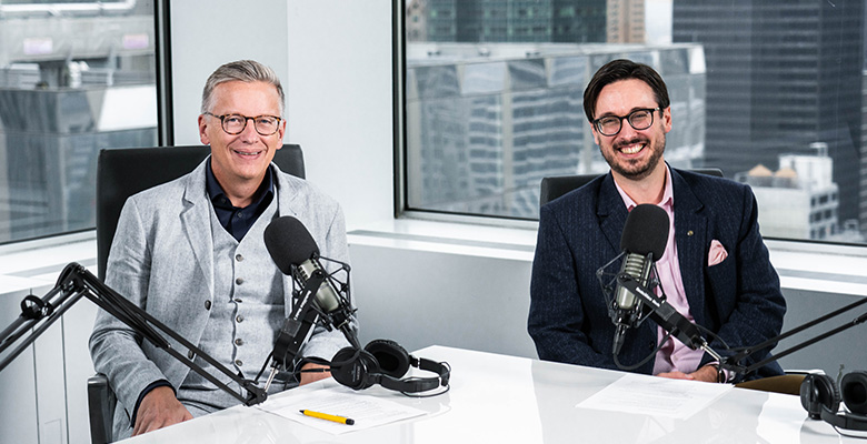 Photography of Paul Ricard and Sean Ringstead looking at the camera with microphones.