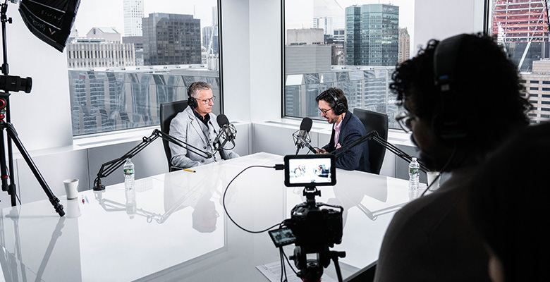 Photography of Paul Ricard's and Sean Ringstead's podcast recorded by a cameraman.