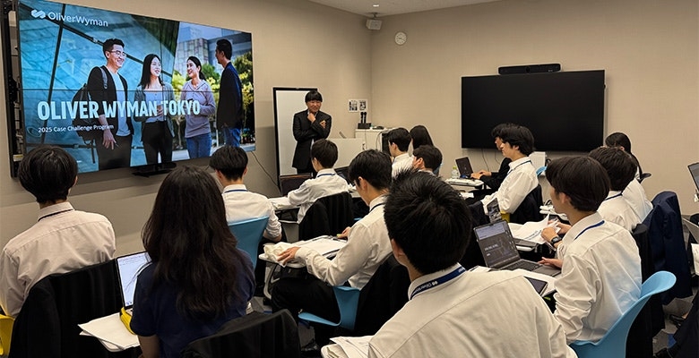 Audience listening to a speaker in a Tokyo office during a workshop.