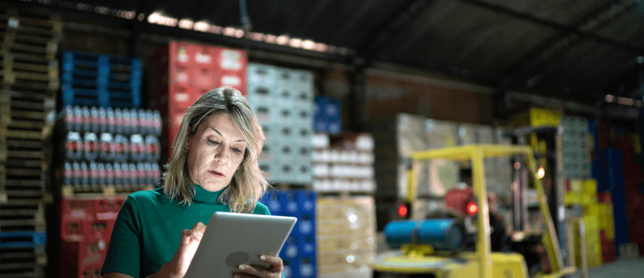 Woman uses a tablet in a warehouse