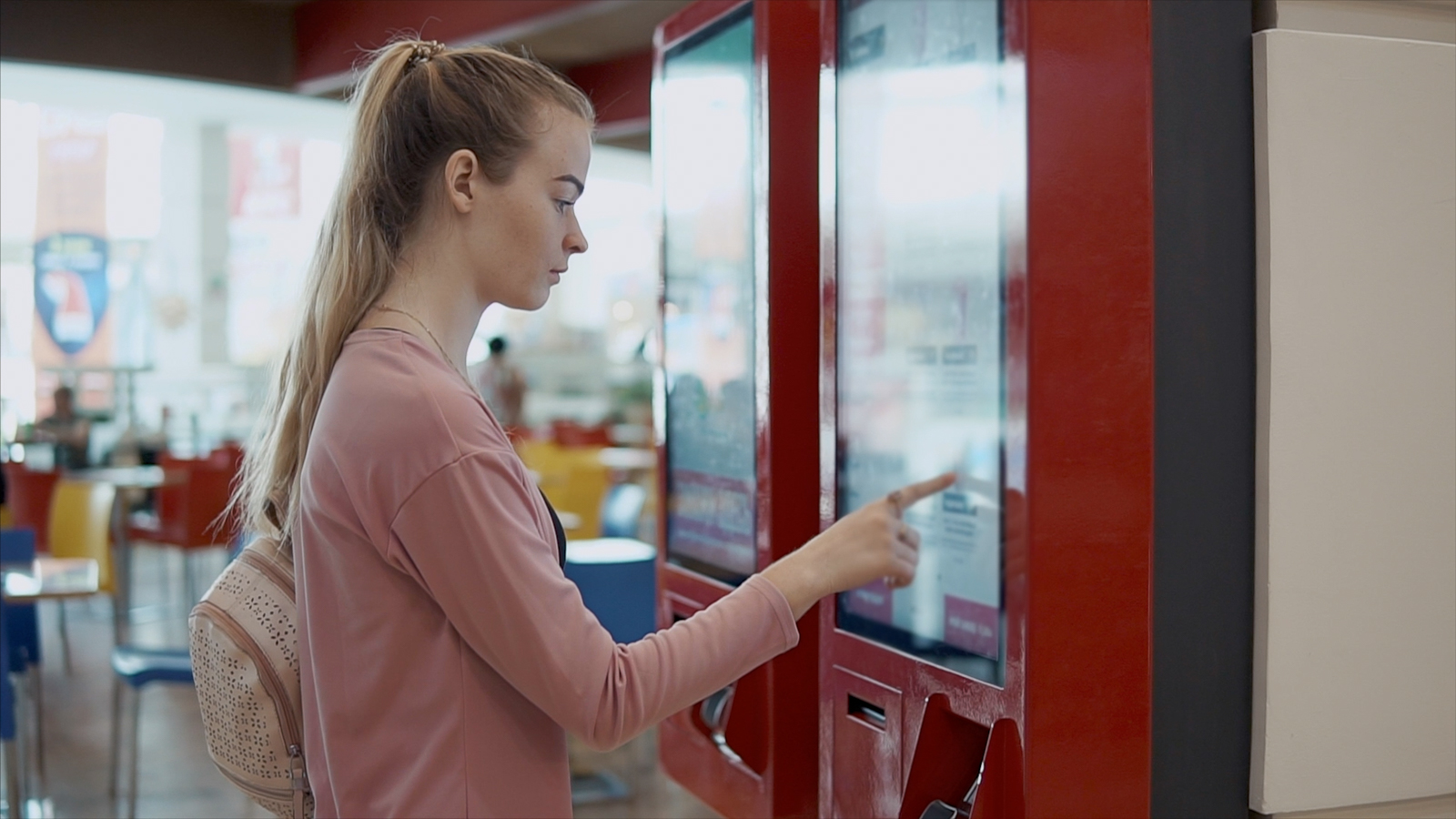 Woman selecting food from a touch screen