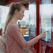 Woman selecting food from a touch screen