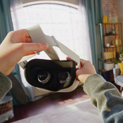 Person putting on virtual reality goggles