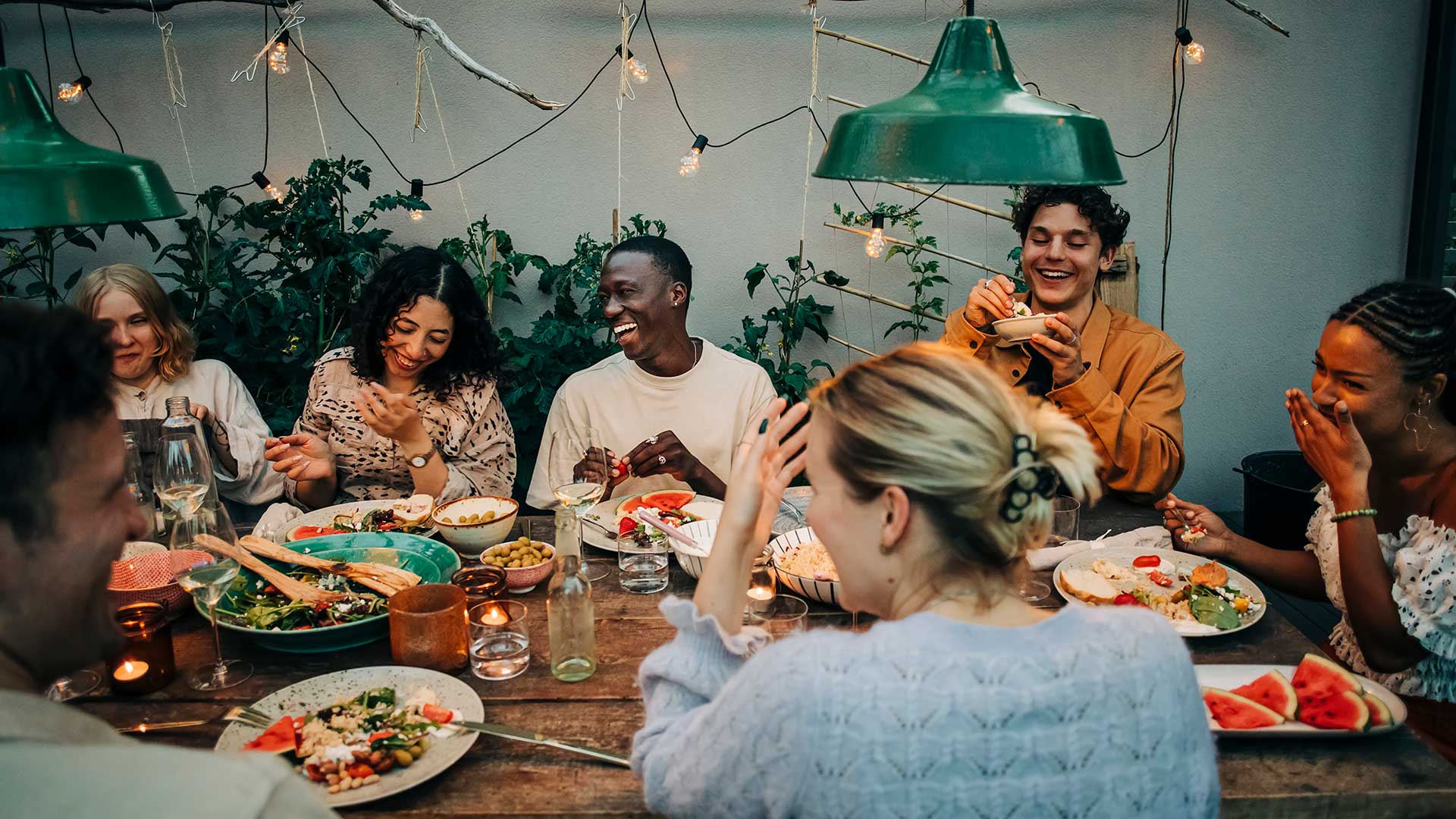 Picture that shows little girl touching a speaker at dinner table with family